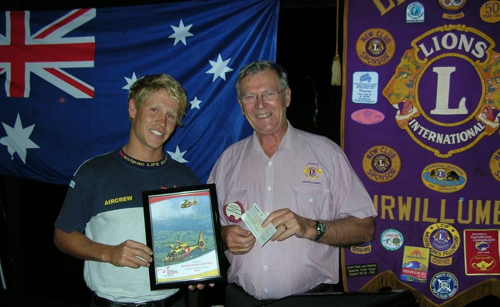Lion Lawrence Anderson presents a cheque to Tom Lee-Lewes and receives a certificate of appreciation. Lion Lawrence Anderson presents a cheque to Tom Lee-Lewes and receives a certificate of appreciation.
